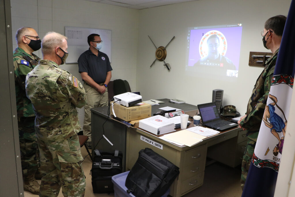 Members of the Virginia Defense Force Support Operations Group provide an over brief to Maj. Gen. Timothy P. Williams